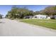 Charming single-story home featuring a well-manicured lawn and mature trees offering ample shade at 1044 Charles St, Clearwater, FL 33755