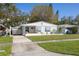 Charming single-story home featuring a well-manicured lawn and inviting curb appeal at 1044 Charles St, Clearwater, FL 33755