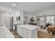 Modern kitchen with white cabinetry, an island with seating, and an open concept design at 1044 Charles St, Clearwater, FL 33755