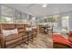 Comfortable sun room with a ceiling fan, wood-look floors, and lots of natural light at 1044 Charles St, Clearwater, FL 33755