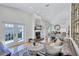 Bright living room features high ceilings, a fireplace, and an open layout leading to the dining area at 1160 26Th N Ave, St Petersburg, FL 33704