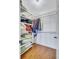 Bright walk-in closet features custom shelving, hanging racks, and wood floors at 1160 26Th N Ave, St Petersburg, FL 33704