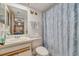 Bathroom featuring vanity with sink, mirror, and shower/tub combination with curtain at 11800 Park Blvd # 505, Seminole, FL 33772