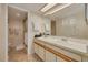 Bathroom featuring double sinks and a shower with glass door at 11800 Park Blvd # 505, Seminole, FL 33772