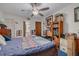 Comfortable bedroom with a full bed, ensuite bathroom, and a ceiling fan at 11800 Park Blvd # 505, Seminole, FL 33772