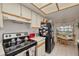 Bright kitchen with white cabinets, black appliances, and a cozy dining area at 11800 Park Blvd # 505, Seminole, FL 33772