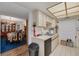 Well-lit kitchen featuring white cabinets, modern appliances, and view into dining area at 11800 Park Blvd # 505, Seminole, FL 33772