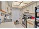 Efficient kitchen features white cabinets, a stainless steel oven, and practical layout at 11800 Park Blvd # 505, Seminole, FL 33772