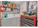 Functional laundry room with washer, dryer, storage shelves, and tool chest at 11800 Park Blvd # 505, Seminole, FL 33772