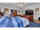 Cozy bedroom featuring a large bed, traditional wooden furniture, and natural lighting at 11800 Park Blvd # 505, Seminole, FL 33772