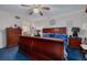 Comfortable bedroom with a ceiling fan, a large wooden bed, and classic decor at 11800 Park Blvd # 505, Seminole, FL 33772
