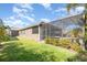 A large backyard with a screened-in pool area and lush green landscaping at 11930 Perennial Pl, Bradenton, FL 34211