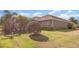 The backyard features tropical landscaping that complements the home's neutral color palette at 11930 Perennial Pl, Bradenton, FL 34211