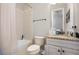 The bathroom features a shower over tub, a sink with storage, and a dark granite countertop at 11930 Perennial Pl, Bradenton, FL 34211