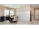 Elegant dining room boasting a modern chandelier, wainscoting, and a table for six with upholstered chairs at 11930 Perennial Pl, Bradenton, FL 34211
