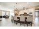 Gourmet kitchen featuring granite countertops, a large island, stainless steel appliances, and pendant lighting at 11930 Perennial Pl, Bradenton, FL 34211