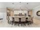 Bright, open kitchen with a large island, granite countertops, seating, stainless steel appliances, and pendant lighting at 11930 Perennial Pl, Bradenton, FL 34211
