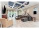 Cozy living room showcasing a coffered ceiling, neutral decor, comfortable seating, and an open floor plan at 11930 Perennial Pl, Bradenton, FL 34211