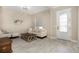 Cozy living room featuring tile floors, neutral paint, modern furnishings, and a front door with decorative glass at 11930 Perennial Pl, Bradenton, FL 34211
