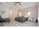 Inviting main bedroom with a tray ceiling, panel accent wall, neutral decor, and luxury vinyl plank flooring at 11930 Perennial Pl, Bradenton, FL 34211