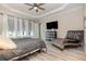 This is the main bedroom that features tray ceilings, a ceiling fan, and an ensuite bathroom at 11930 Perennial Pl, Bradenton, FL 34211