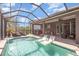 The screened-in patio features a pool, outdoor kitchen, and plenty of seating at 11930 Perennial Pl, Bradenton, FL 34211