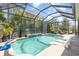 Relax in this private screened-in pool area, surrounded by lush tropical landscaping at 11930 Perennial Pl, Bradenton, FL 34211