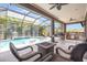 A covered patio that offers a private pool area, an outdoor kitchen, and comfortable seating at 11930 Perennial Pl, Bradenton, FL 34211