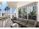 Balcony with outdoor seating area, sliding glass doors, and a view of the community and tropical foliage at 1209 E Cumberland Ave # 502, Tampa, FL 33602