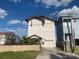 Two-story home featuring a private driveway and a charming covered entryway with lush landscaping at 13253 Boca Ciega Ave, Madeira Beach, FL 33708