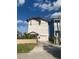 Two-story home featuring a private driveway and a charming covered entryway with lush landscaping at 13253 Boca Ciega Ave, Madeira Beach, FL 33708