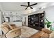 Spacious living room with hardwood floors, leather couches, and decorative shelving at 1337 Gangplank Dr, Valrico, FL 33594