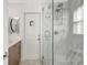 Bright bathroom featuring a glass shower with marble accents and mosaic tile flooring at 1389 47Th Ne Ave, St Petersburg, FL 33703