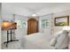 Cozy bedroom with a large wooden armoire, natural light, and a comfortable bed at 1389 47Th Ne Ave, St Petersburg, FL 33703