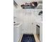 Bright laundry room with modern machines, overhead storage, and a stylish mat at 1389 47Th Ne Ave, St Petersburg, FL 33703
