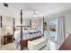 Main bedroom with a four poster bed and access to the patio and pool at 1389 47Th Ne Ave, St Petersburg, FL 33703