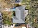 Birds-eye view of the home's roof, surrounded by mature trees, displaying roof condition and neighborhood context at 14809 Tulip Dr, Tampa, FL 33613