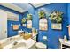 Cozy bathroom with nautical decor, a sink, and a mirror against blue walls at 15 Emerald Bay Dr, Oldsmar, FL 34677
