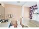 Well-lit bathroom featuring a tub with floral accents and a sink with a mirror at 15 Emerald Bay Dr, Oldsmar, FL 34677