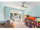 Bright bedroom features a ceiling fan, a bay window, and comfortable furniture at 15 Emerald Bay Dr, Oldsmar, FL 34677