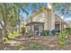 Exterior view of the home with a screened lanai and lush landscaping at 15 Emerald Bay Dr, Oldsmar, FL 34677