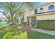 Charming two-story home with a well-maintained lawn and scenic lakeside view at 15 Emerald Bay Dr, Oldsmar, FL 34677