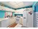 Efficient kitchen featuring white appliances, ample cabinetry, and a window overlooking the backyard at 15 Emerald Bay Dr, Oldsmar, FL 34677