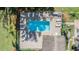 Aerial view of a sparkling community pool with lounge chairs and well-maintained landscaping at 15 Emerald Bay Dr, Oldsmar, FL 34677