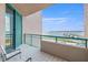 Balcony view of the waterway with chairs and a glass sliding door at 1560 Gulf Blvd # 1202, Clearwater Beach, FL 33767