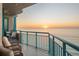 Spacious balcony showcasing ocean views, with a table and chairs for outdoor dining and relaxation at 1560 Gulf Blvd # 1202, Clearwater Beach, FL 33767