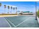 Well-maintained basketball court surrounded by lush palm trees and greenery at 1560 Gulf Blvd # 1202, Clearwater Beach, FL 33767