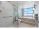 Bathroom with glass shower, soaking tub, and ocean view at 1560 Gulf Blvd # 1202, Clearwater Beach, FL 33767