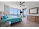 Sunny bedroom featuring a ceiling fan and a beautiful ocean view at 1560 Gulf Blvd # 1202, Clearwater Beach, FL 33767