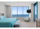Bright bedroom with ocean view, hardwood floors, and light blue accents at 1560 Gulf Blvd # 1202, Clearwater Beach, FL 33767